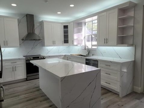 White shaker kitchen with a quartz waterfall island